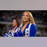 A Cowboys cheerleader looks on