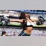 An Eagles cheerleader mid-dance