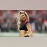A cheerleader comes to a rest