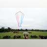 A formation of Royal Air Force jets streaks across the sky with red, white, and blue trails above Windsor Castle’s ceremony.