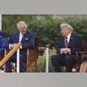 King Charles III smiles while seated next to Donald Trump, who gestures during their conversation at Windsor Castle.