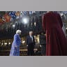 Trump and Melania with stained glass and flags overhead