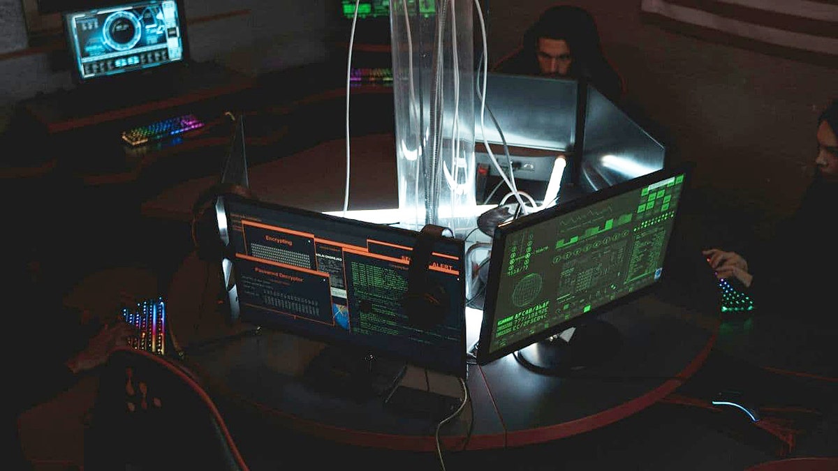 Kido nursery data breach exposes 8,000 children's personal information 1 Computer monitors connected to wires display code.