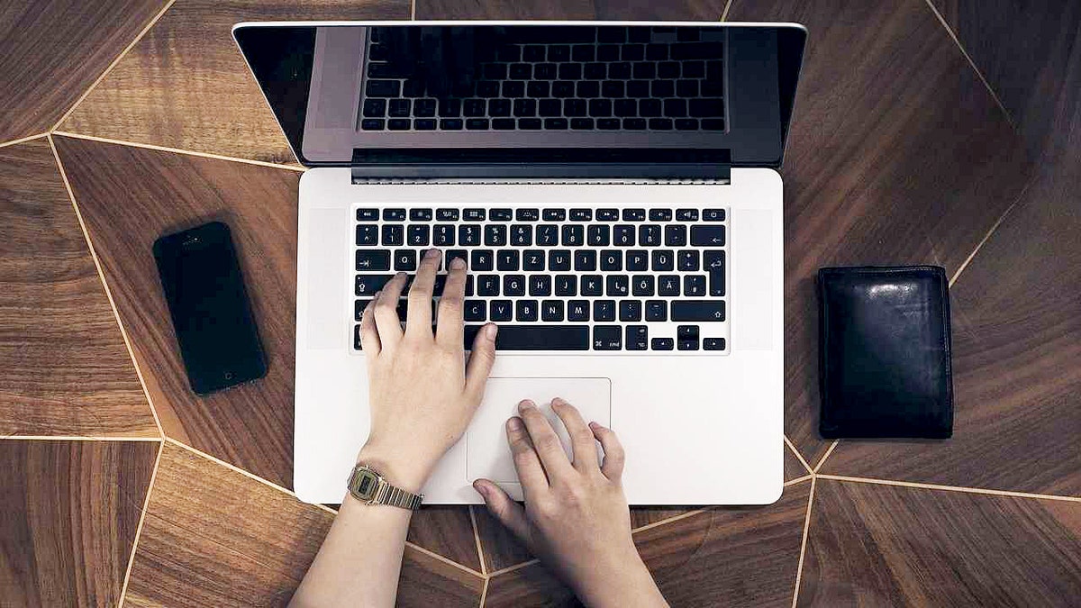 AI phishing scams are getting smarter, here's how to protect yourself 1 A woman types on a MacBook laptop.