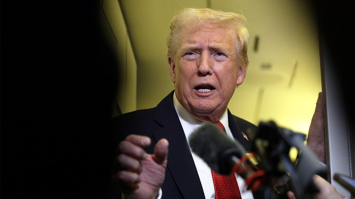 trump speaks to reporters aboard Air Force One