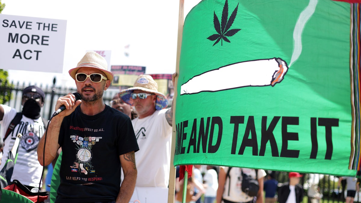 Activist holds microphone at annual marijuana protest