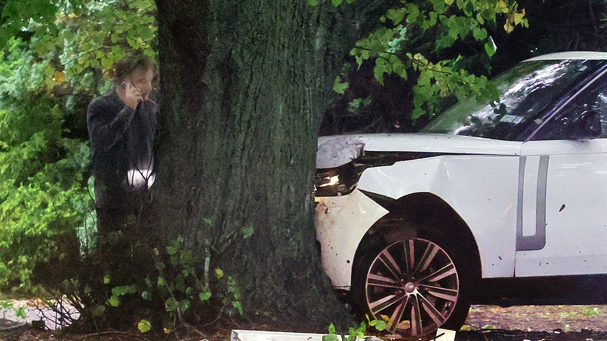 Alec Baldwin surveys damage from car crash