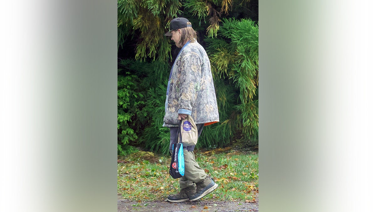 Stephen Baldwin wears winter coat near car crash