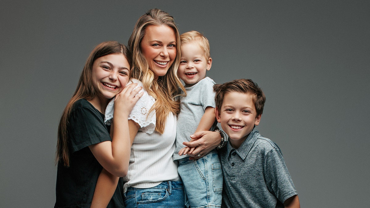 Amber Smith smiling and surrounded by her children.