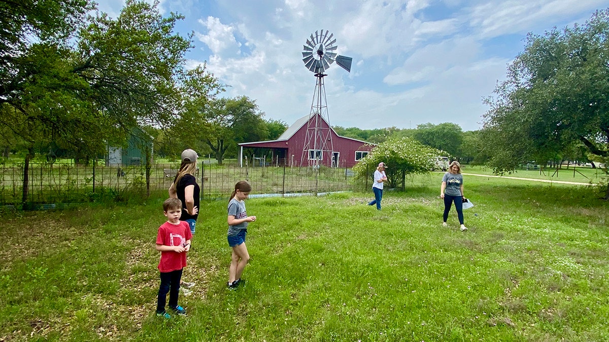 Amber Smith and her family walking on farmland in Texas.