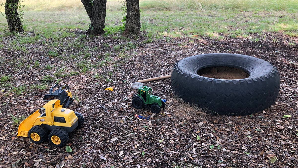 River Smith's toys on the ground next to a tire.