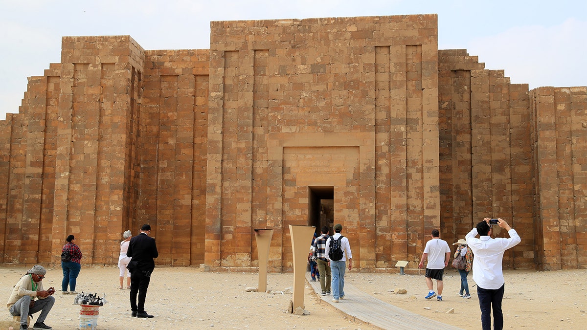Dozens of tourists looking outside necropolis
