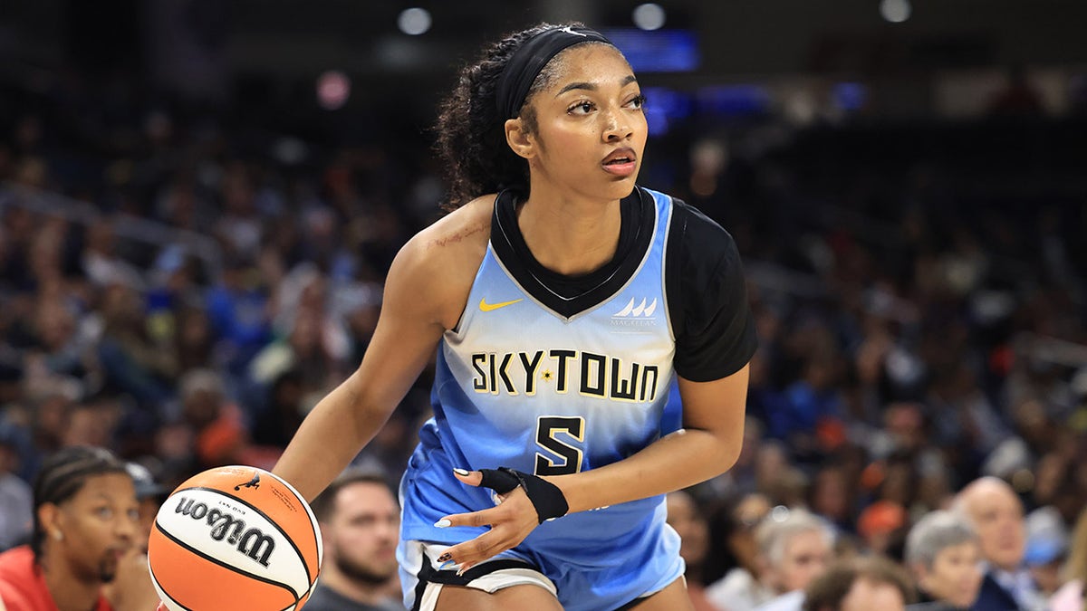 Angel Reese dribbling a basketball during a game at Wintrust Arena
