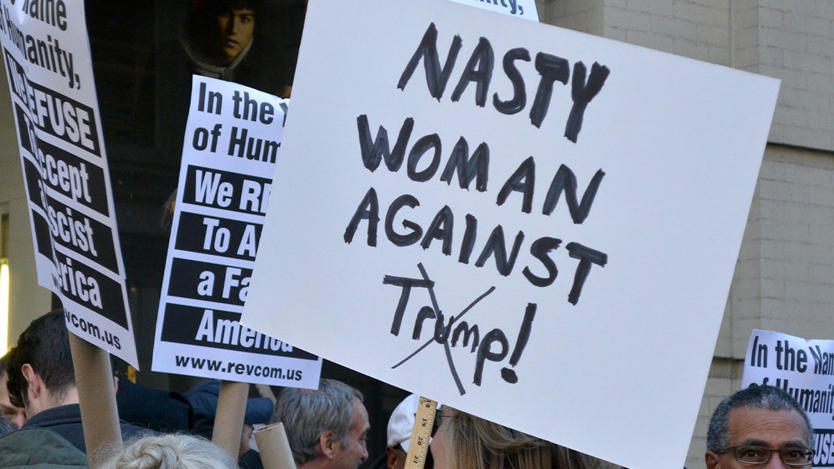 Nasty pistillate against Trump sign
