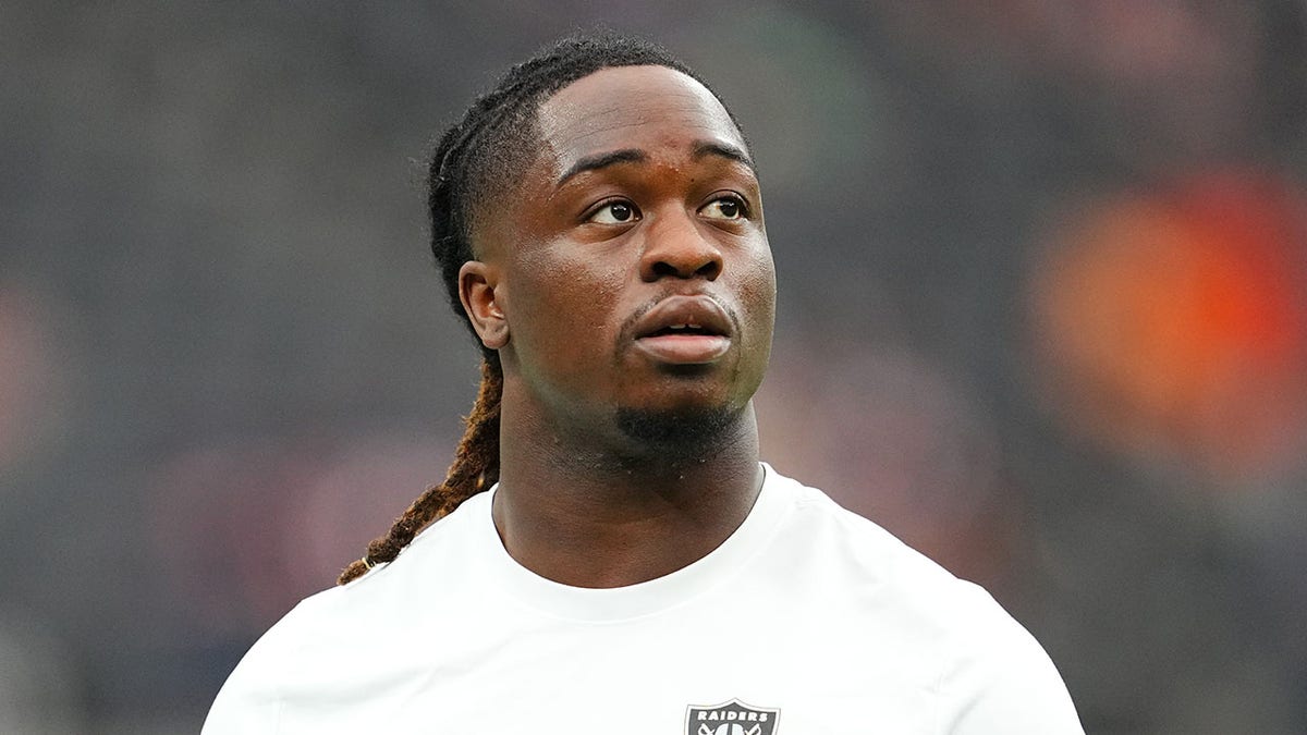 Ashton Jeanty looks up on field