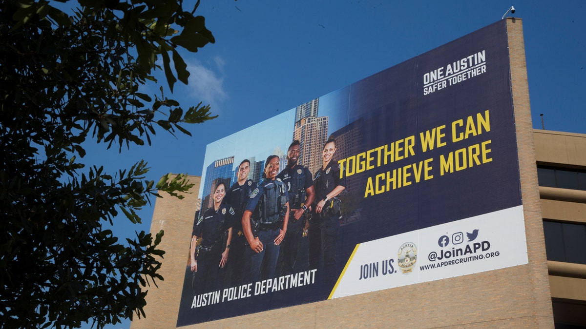 Image of a poster on the side of the Austin Police Department building