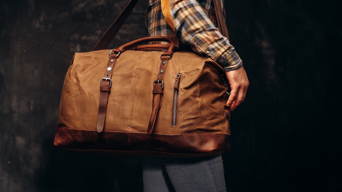 Brown duffel bag on men's shoulder