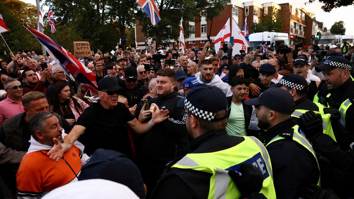 Protesters standoff with police officers in Epping