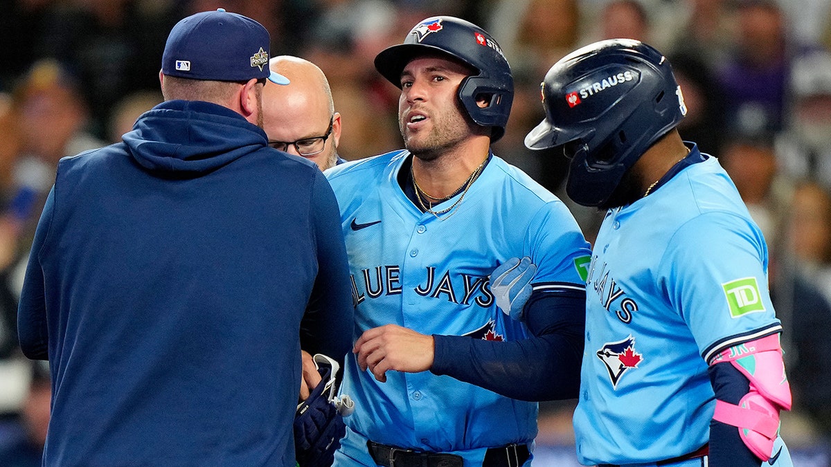 George Springer helped off the field