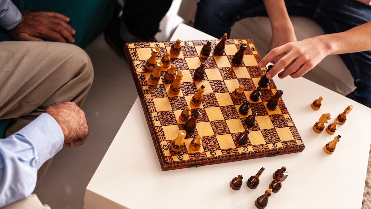 Men playing chess in the living room