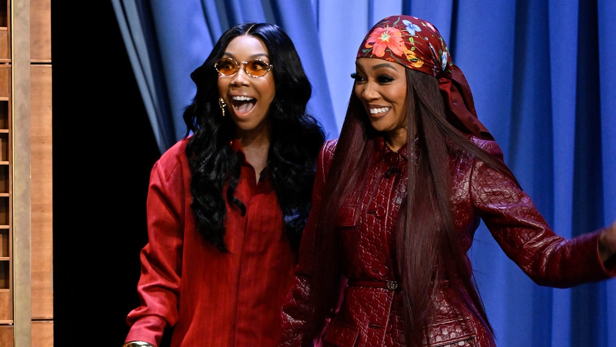 Brandy and Monica wear matching red outfits