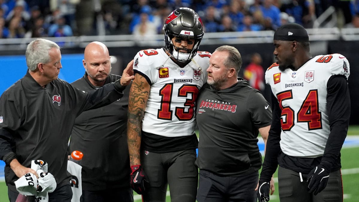 Mike Evans is helped off the field