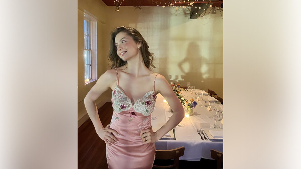 Carys Zeta Douglas wears a pink and white dress for her 21st birthday