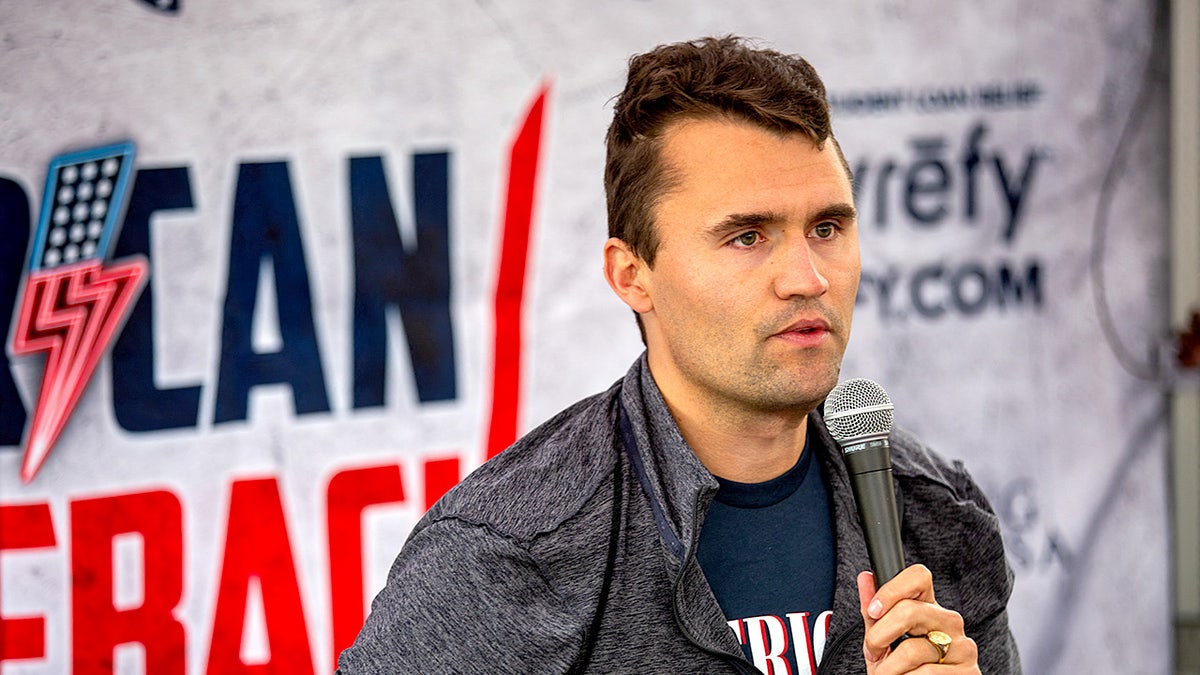 Conservative activist Charlie Kirk holding a microphone debating students at California State University Northridge