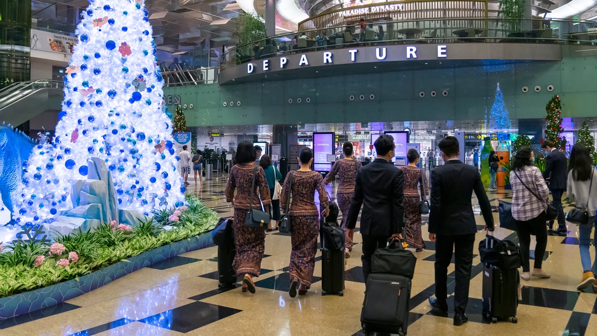 traveler walking in airport during christmas season