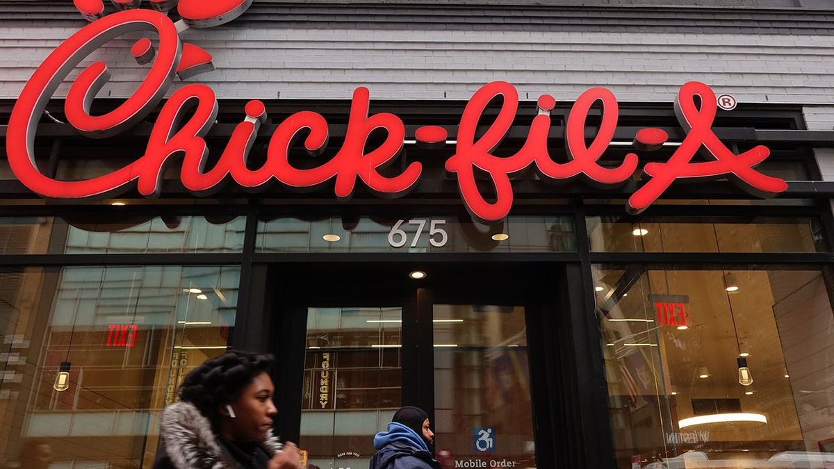 People walking past a Chick-fil-A location in NYC. Dutch Bros tied Chick-fil-A for the highest satisfaction score in the 2025 Drive-Thru Study.