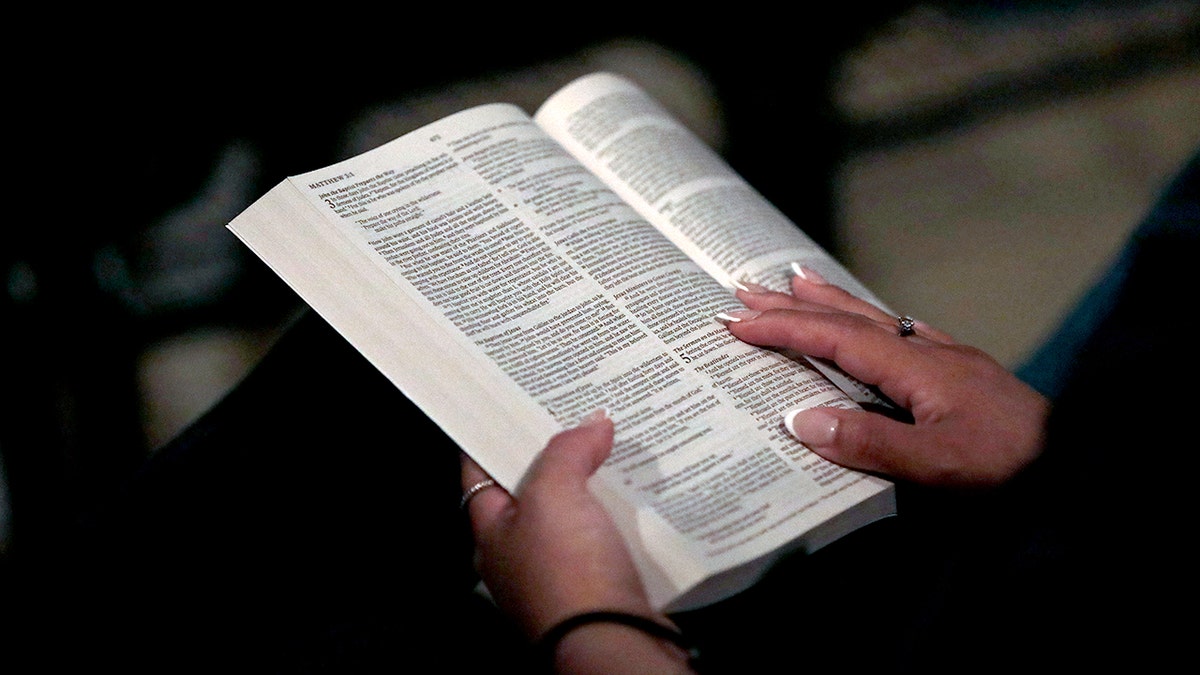 Woman reading her Bible.