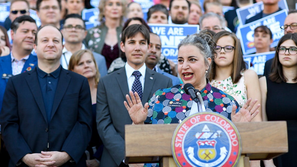 Lawmakers speak at a bill signing ceremony for a ban on so-called "conversion therapy" in Colorado. 