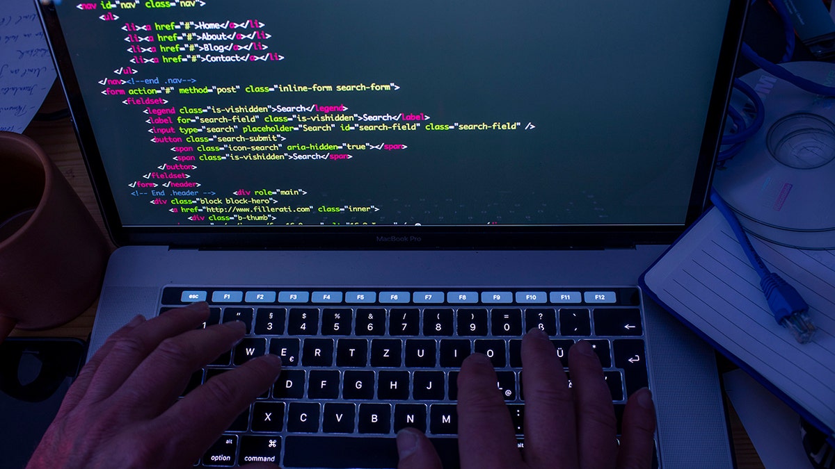 Hacker writing code.