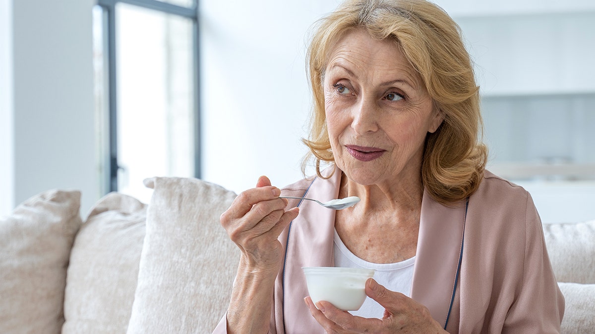 Older woman eating yogurt