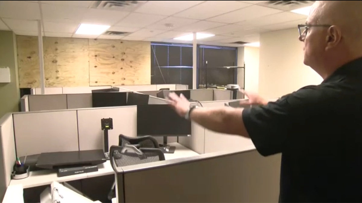 Acting ICE Field Office Director showing an office with boarded up windows
