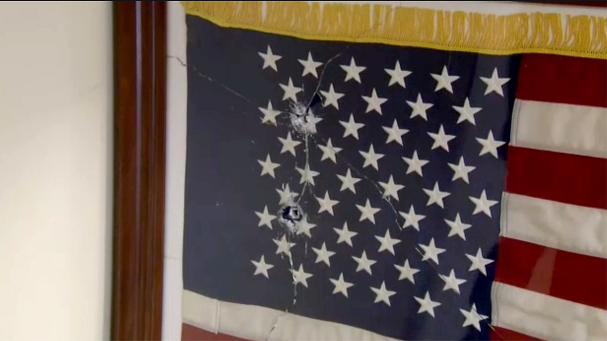 American flag with bullet holes