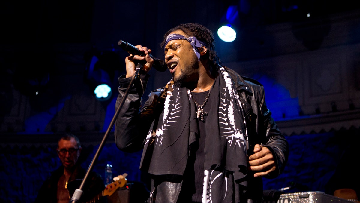 D'Angelo wears a bandana while performing on stage