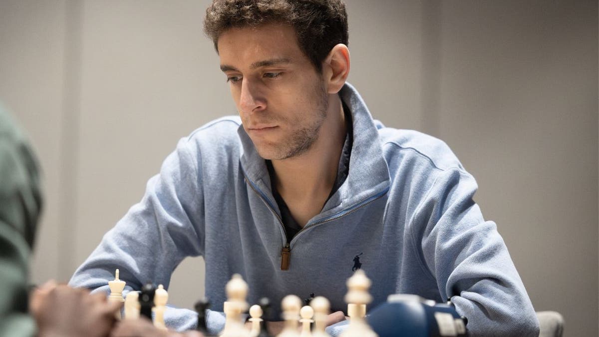 Daniel Naroditsky focuses on a chessboard during a tournament before his death at 29.