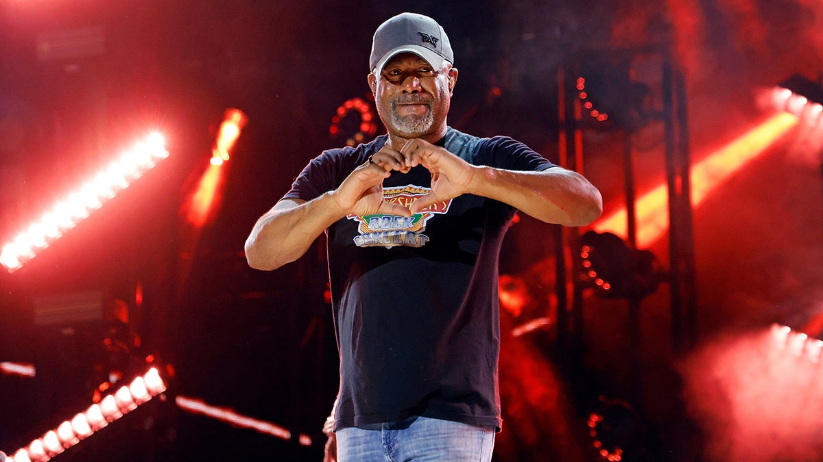 Darius Rucker making a heart with his hands while on stage at CMA Fest in June 2025.