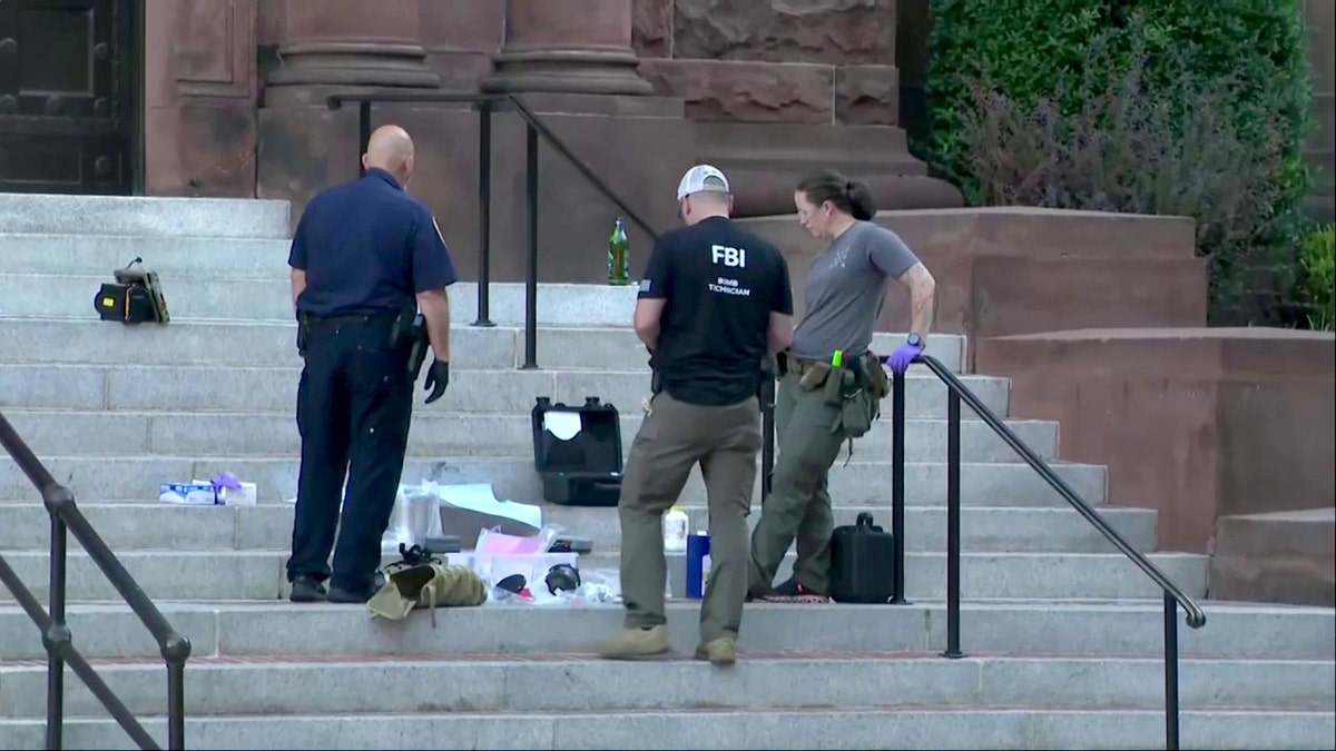 investigators looking at suspect's belongs on steps of Cathedral