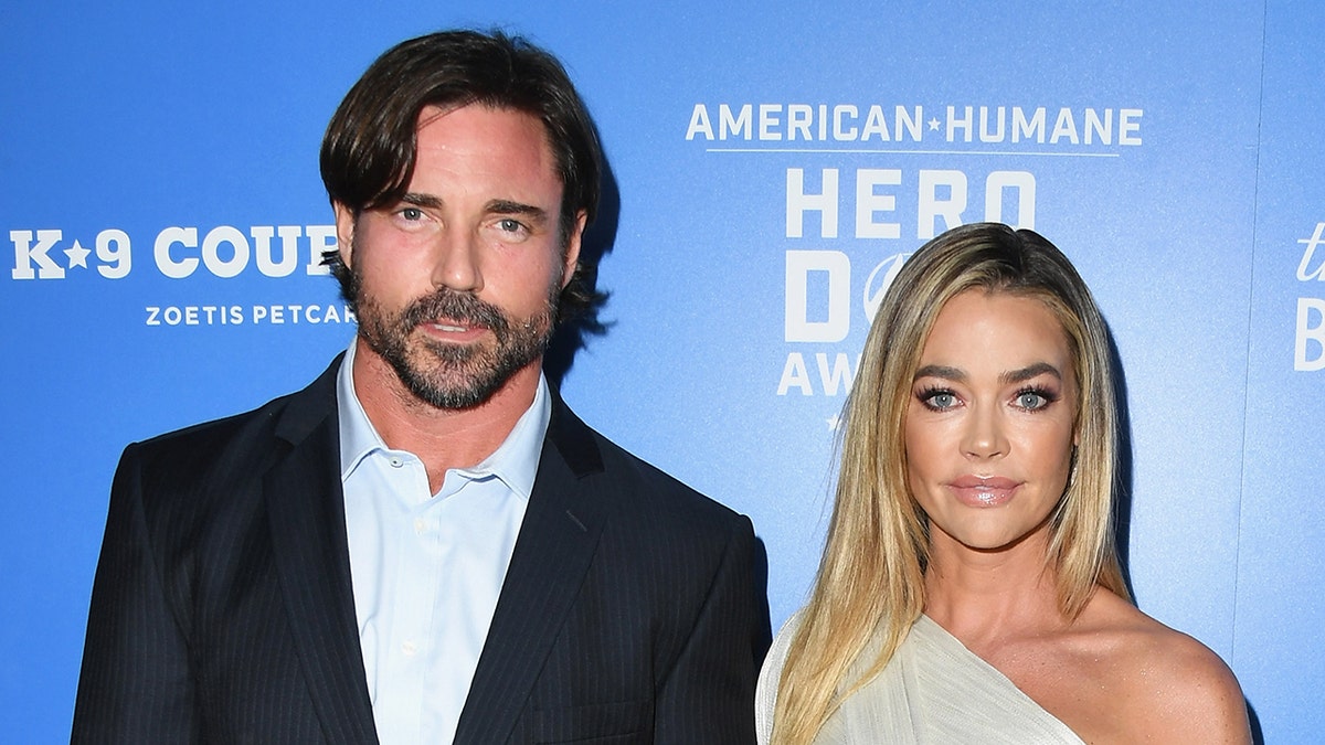 Aaron Phypers and Denise Richards standing on a red carpet