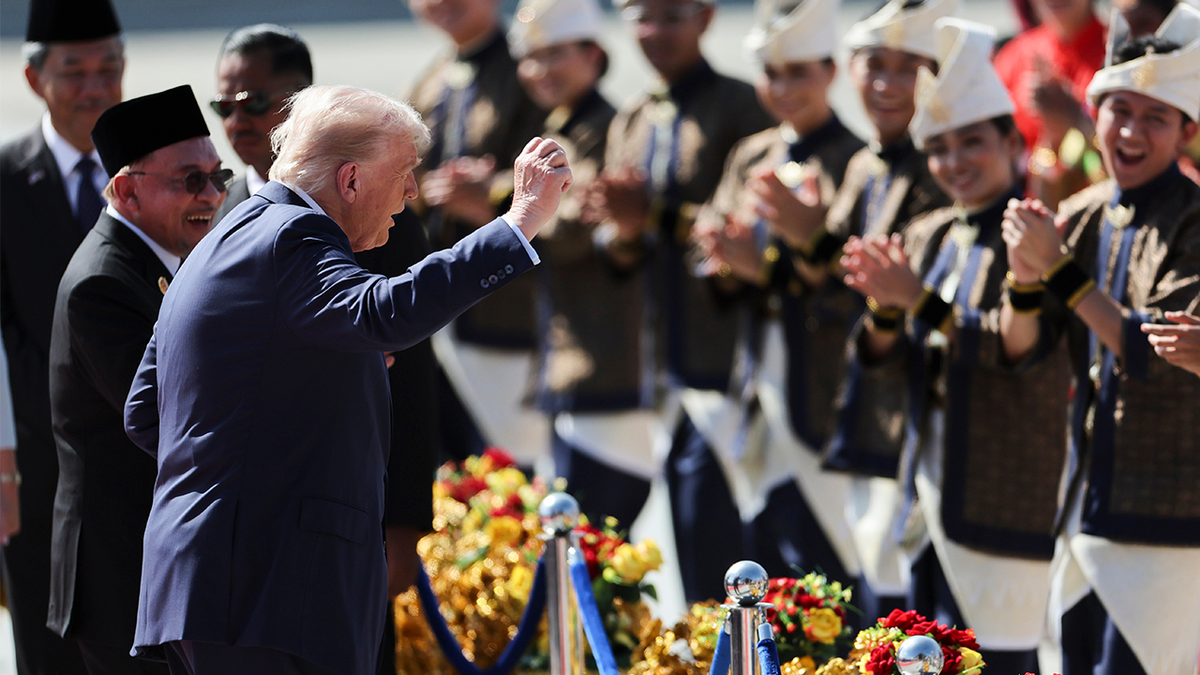 U.S. President Donald Trump reacts to dancing performers
