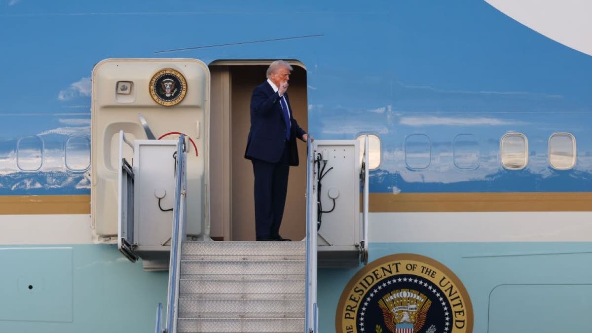Donald Trump waves from Air Force One
