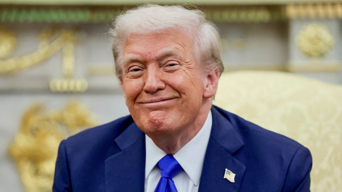Donald Trump smiles in the Oval Office