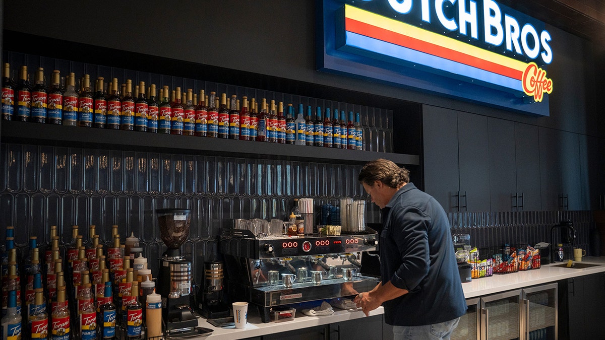 Man making a coffee drink at Dutch Bros coffee shop.