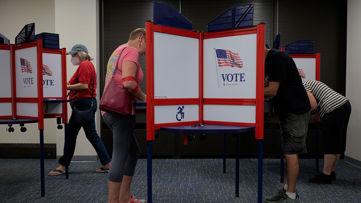 Voters cast their ballots on the first day of early voting in VA