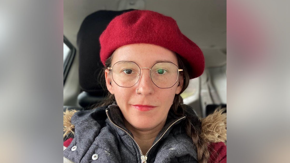 Erica Anderson in a red beret in a selfie photo