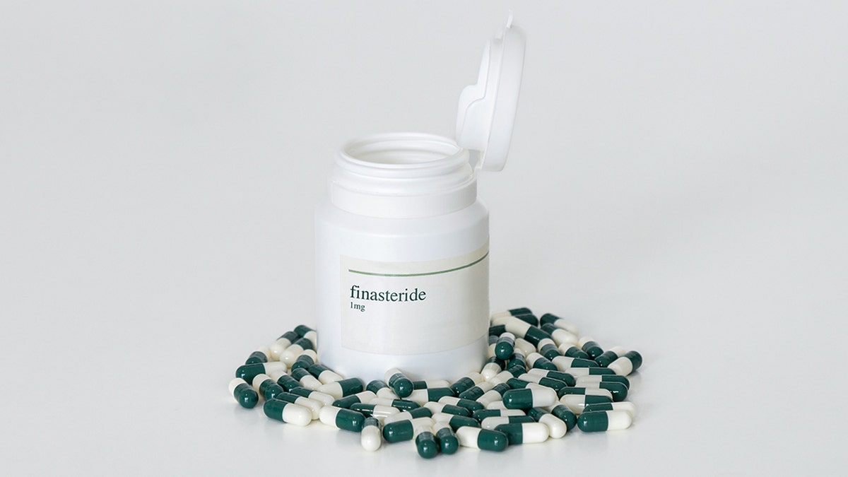 A pill bottle of finasteride capsules