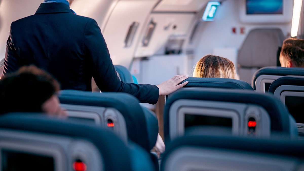 Flight attendant checking that everything is ready for take-off