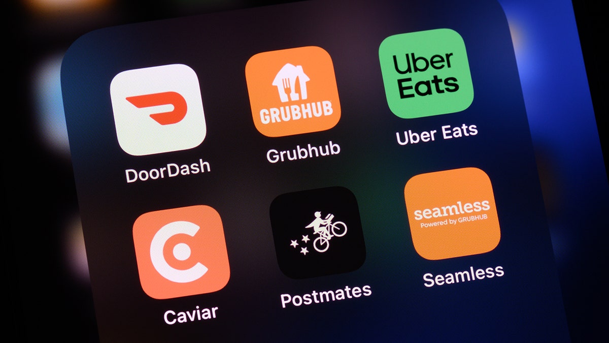 Food delivery apps seen on a screen, including DoorDash, GrubHub, Uber Eats, Caviar, Postmates and Seamless.